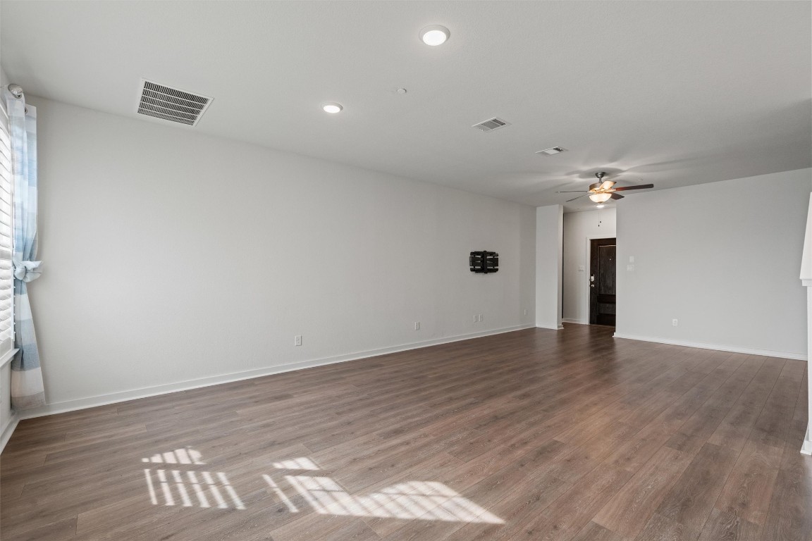 2500 Forest Creek Drive, Unit 302 Round Rock, TX 78665 - Photo 5 of 27 wooden floor in an empty room with a window