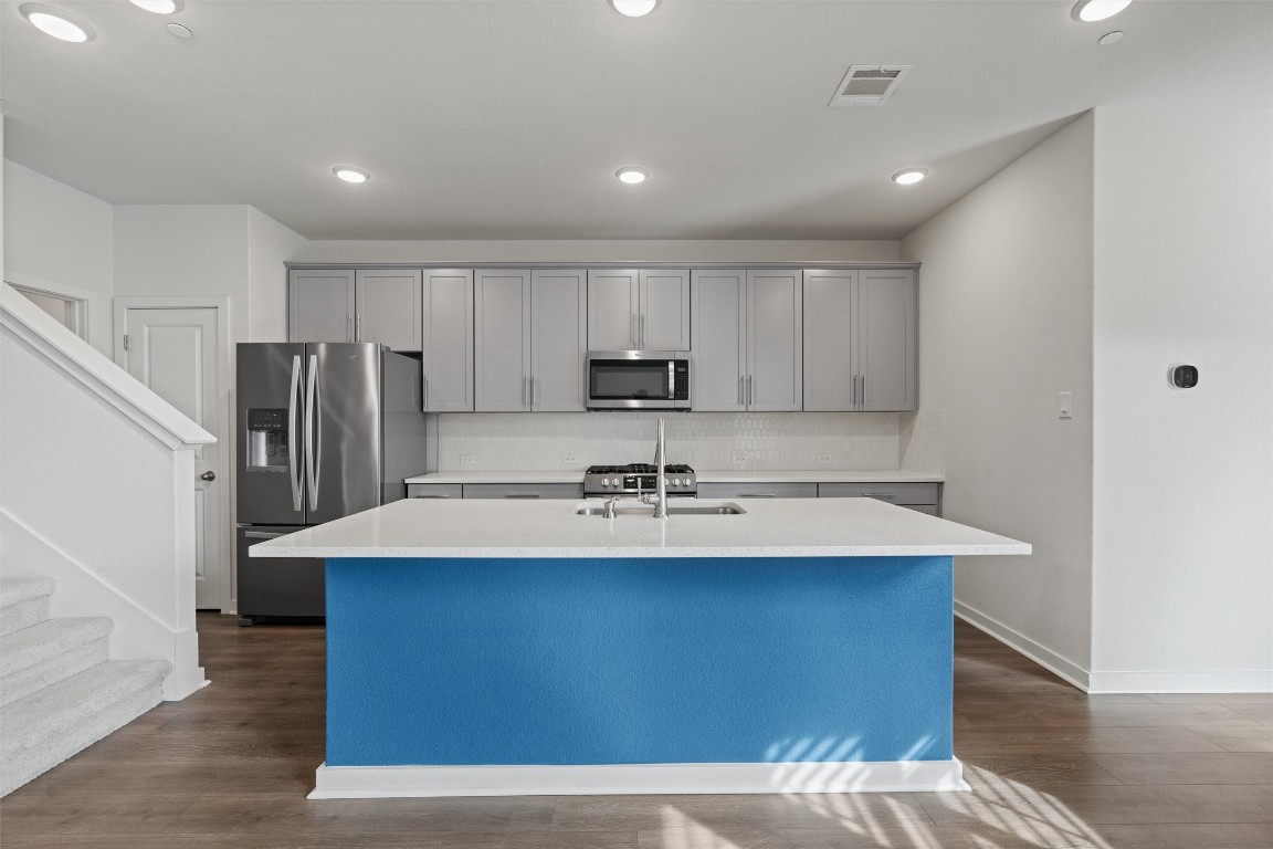 2500 Forest Creek Drive, Unit 302 Round Rock, TX 78665 - Photo 6 of 27 a kitchen with kitchen island a sink appliances and cabinets