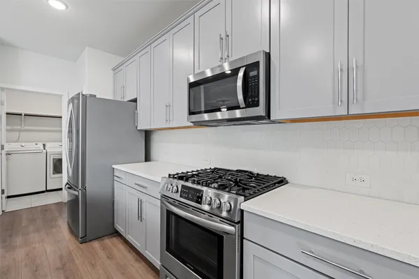 a kitchen with a stove microwave and sink