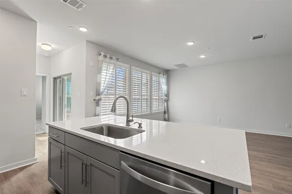a kitchen with a sink and large window