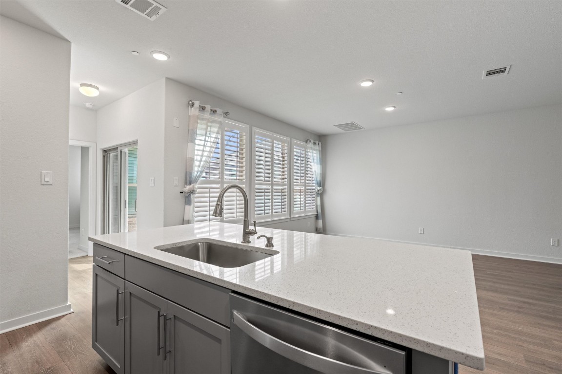 2500 Forest Creek Drive, Unit 302 Round Rock, TX 78665 - Photo 9 of 27 a kitchen with a sink and large window