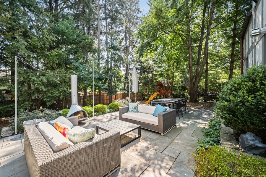 505 Ridge Road Kenilworth, IL 60043 - Photo 23 of 26 a view of a patio with couches and a table and chairs with garden view