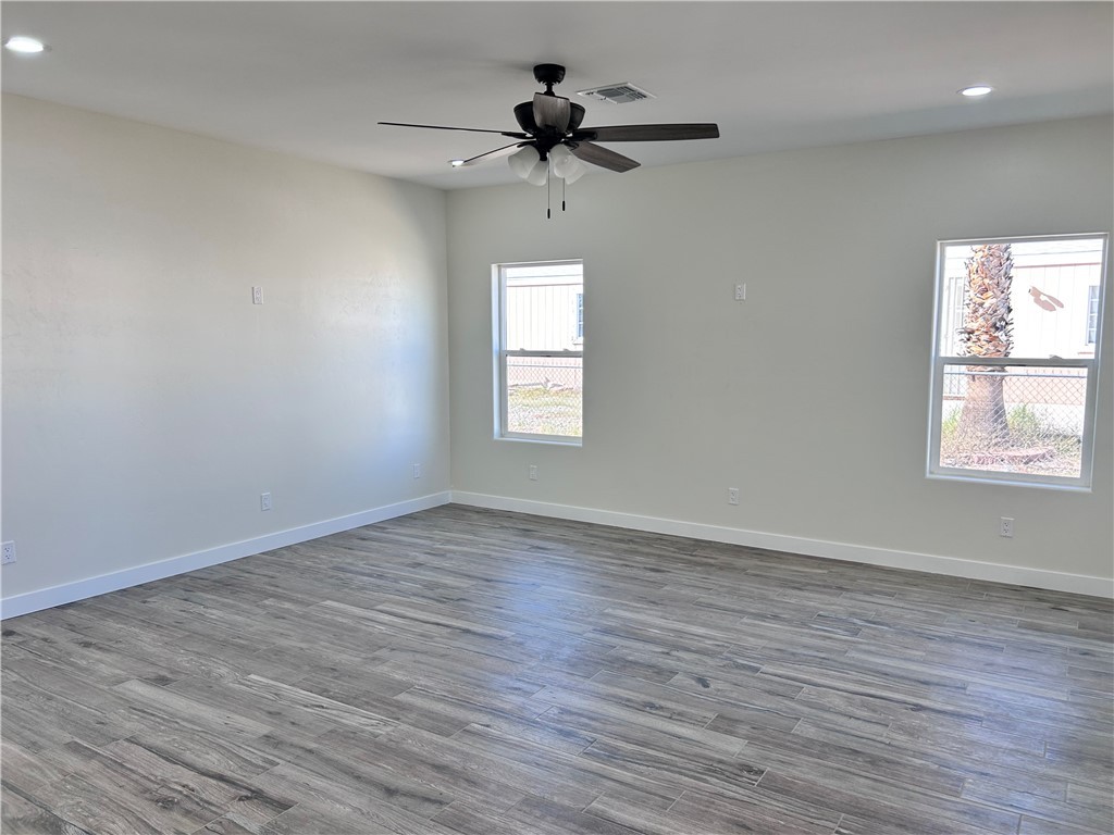 1266 Wilson Road Bullhead City, AZ 86442 - Photo 11 of 29 Spare room featuring recessed lighting, dark wood-style flooring, and a ceiling fan