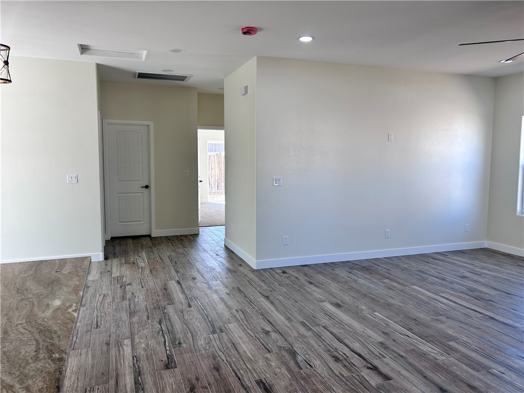 1266 Wilson Road Bullhead City, AZ 86442 - Photo 12 of 29 Unfurnished room with wood finished floors and recessed lighting