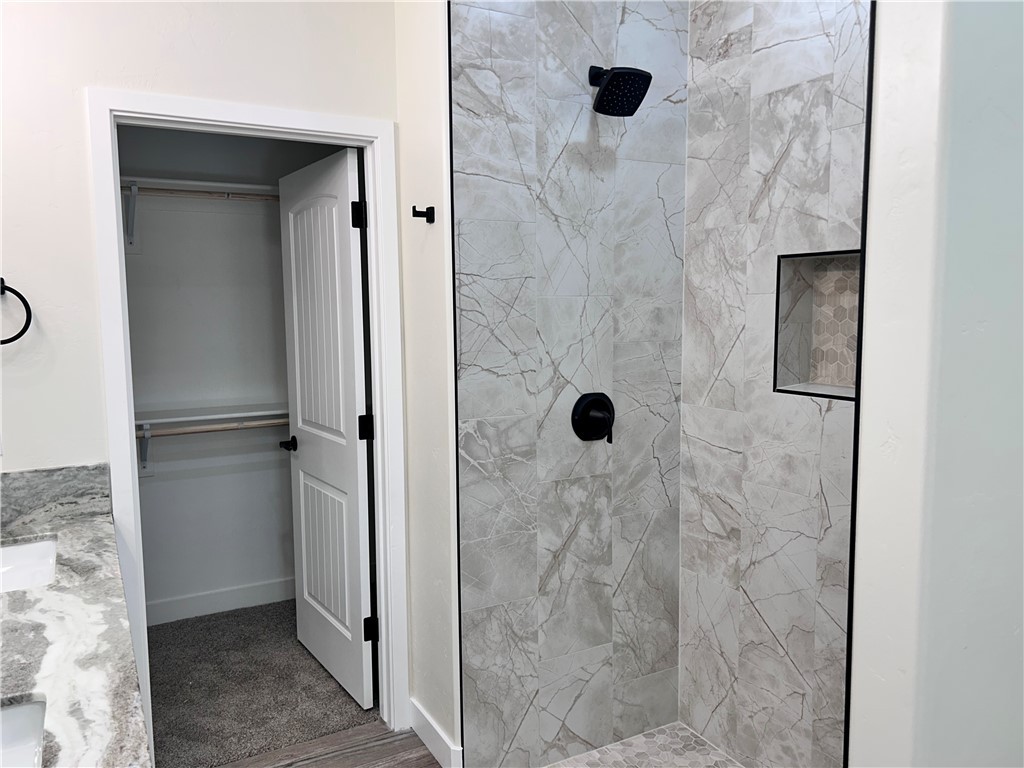 1266 Wilson Road Bullhead City, AZ 86442 - Photo 20 of 29 Full bathroom with tiled shower, double vanity, and a walk in closet