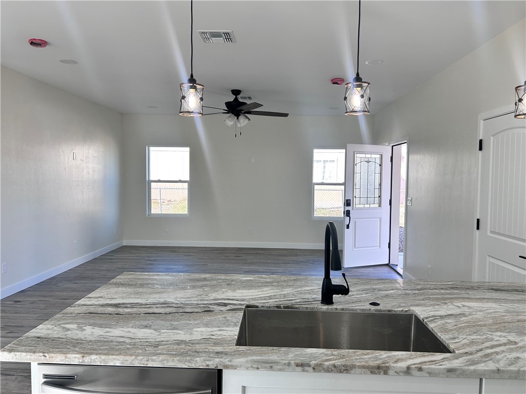1266 Wilson Road Bullhead City, AZ 86442 - Photo 8 of 29 Kitchen with light stone counters, decorative light fixtures, and plenty of natural light