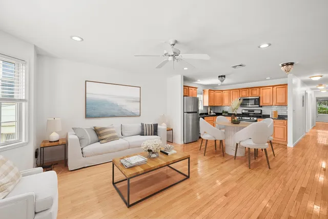 a living room with furniture and kitchen view