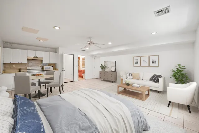 a living room with furniture and kitchen view