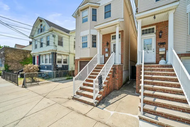 a view of a building with stairs and a bench