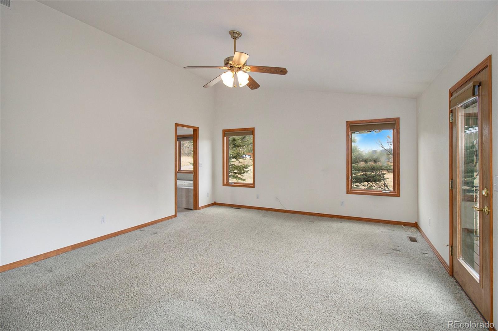 43 Forest Ridge Circle Bailey, CO 80421 - Photo 15 of 43 an empty room with windows and chandelier fan