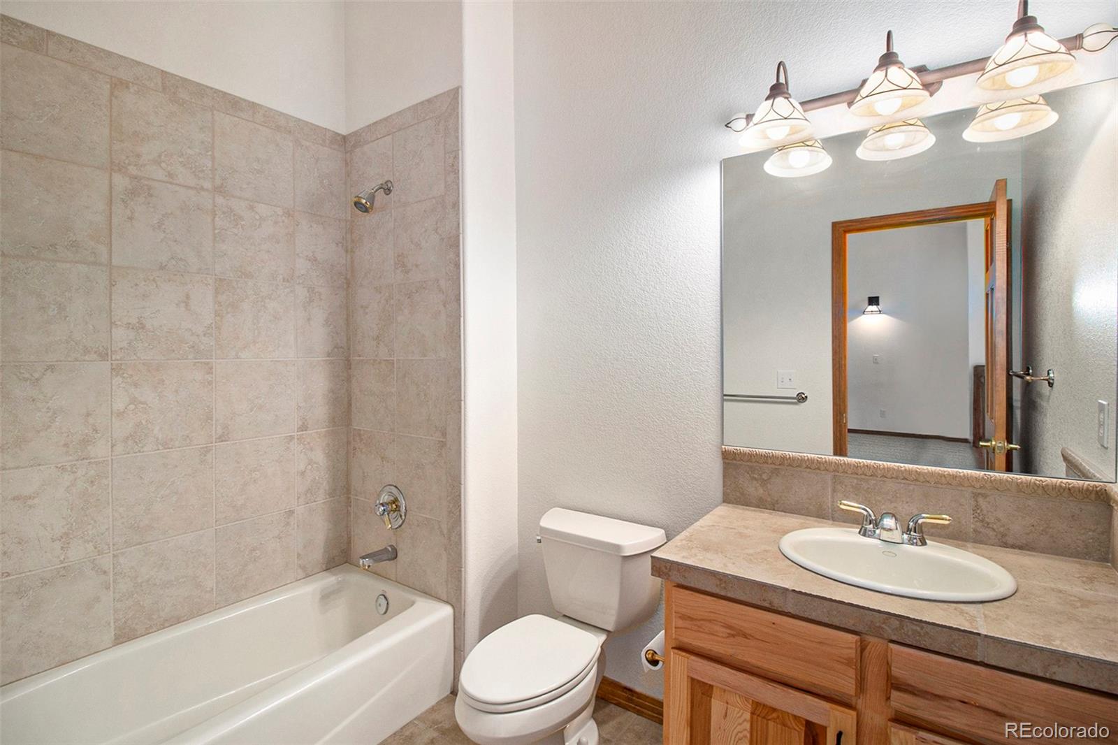 43 Forest Ridge Circle Bailey, CO 80421 - Photo 26 of 43 a bathroom with a granite countertop sink a toilet and bathtub
