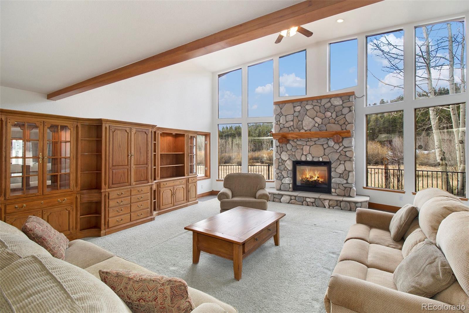 43 Forest Ridge Circle Bailey, CO 80421 - Photo 6 of 43 a living room with furniture or outdoor view and a fireplace