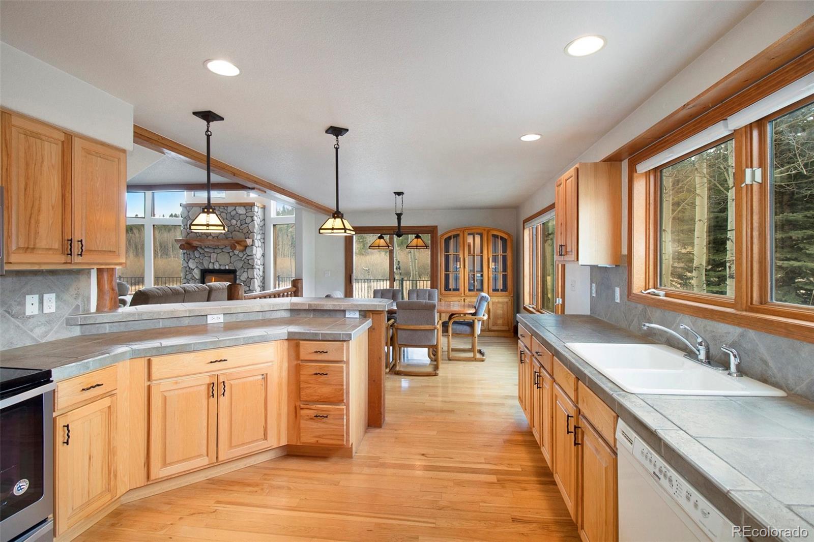 43 Forest Ridge Circle Bailey, CO 80421 - Photo 7 of 43 a large kitchen with lots of counter space and a sink