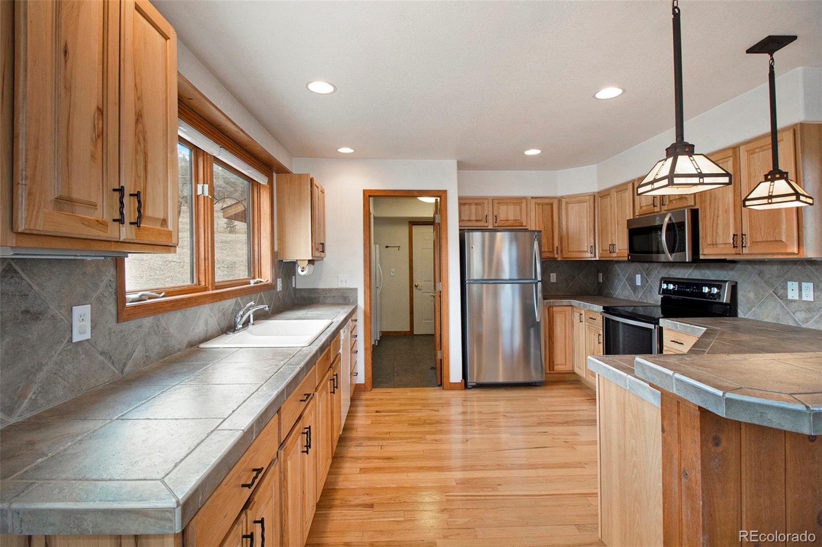 43 Forest Ridge Circle Bailey, CO 80421 - Photo 8 of 43 a kitchen with stainless steel appliances granite countertop a refrigerator a sink and a stove