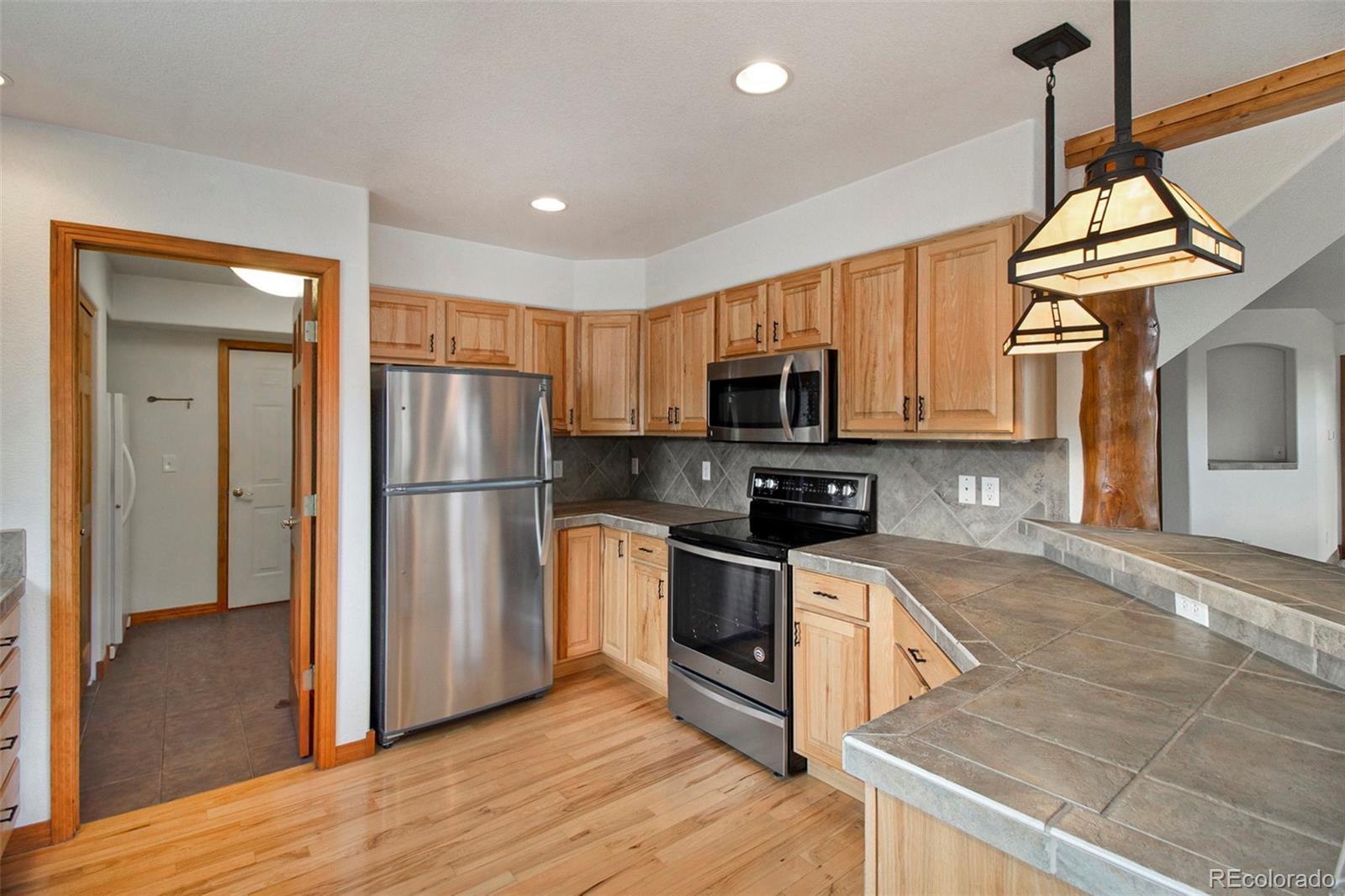 43 Forest Ridge Circle Bailey, CO 80421 - Photo 9 of 43 a kitchen with stainless steel appliances granite countertop a refrigerator a stove top oven a sink and dishwasher