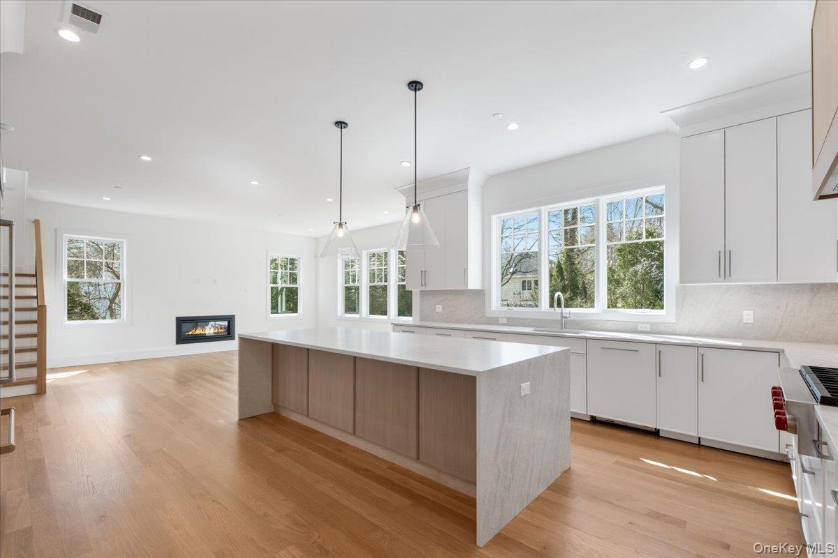 8 Dell Road Scarsdale, NY 10583 - Photo 11 of 41 a kitchen with stainless steel appliances granite countertop a stove a sink a center island and a window