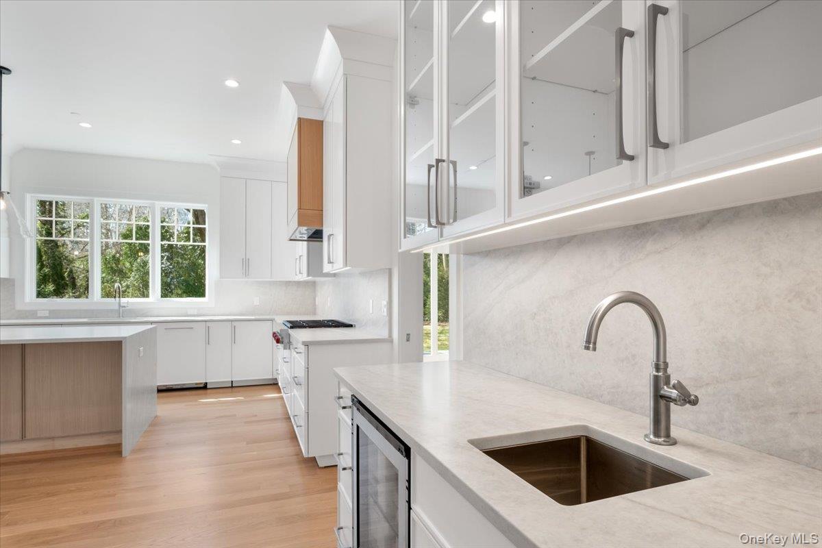 8 Dell Road Scarsdale, NY 10583 - Photo 13 of 41 a kitchen with stainless steel appliances granite countertop a sink a stove and a wooden floors