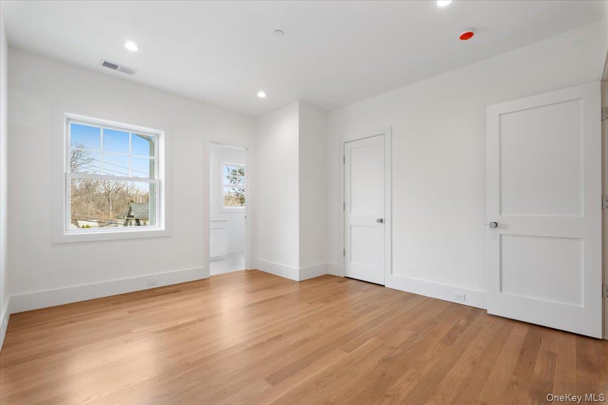 8 Dell Road Scarsdale, NY 10583 - Photo 20 of 41 an empty room with wooden floor and windows