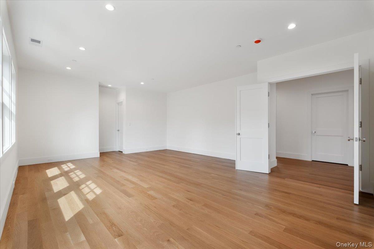 8 Dell Road Scarsdale, NY 10583 - Photo 23 of 41 a view of an empty room with wooden floor and closet