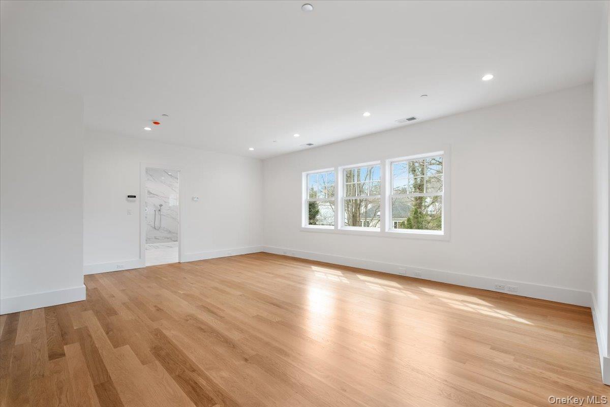8 Dell Road Scarsdale, NY 10583 - Photo 24 of 41 a view of an empty room with wooden floor and a window