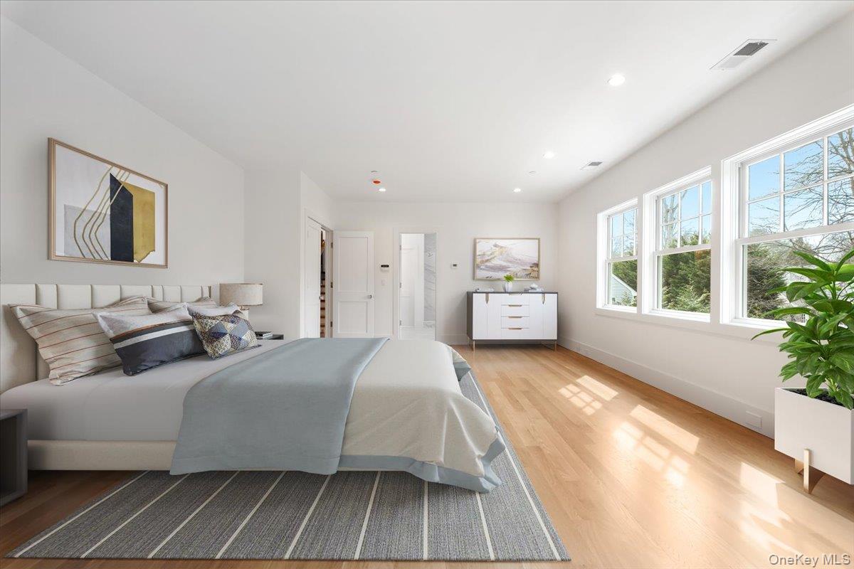 8 Dell Road Scarsdale, NY 10583 - Photo 25 of 41 a bedroom with a large bed and a large window