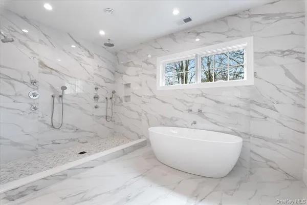a spacious bathroom with a bathtub and shower