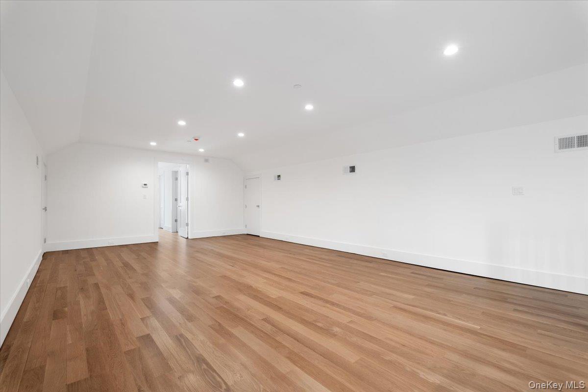 8 Dell Road Scarsdale, NY 10583 - Photo 29 of 41 a view of an empty room with wooden floor and a window