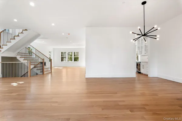 a view of a livingroom with wooden floor and a ceiling fan