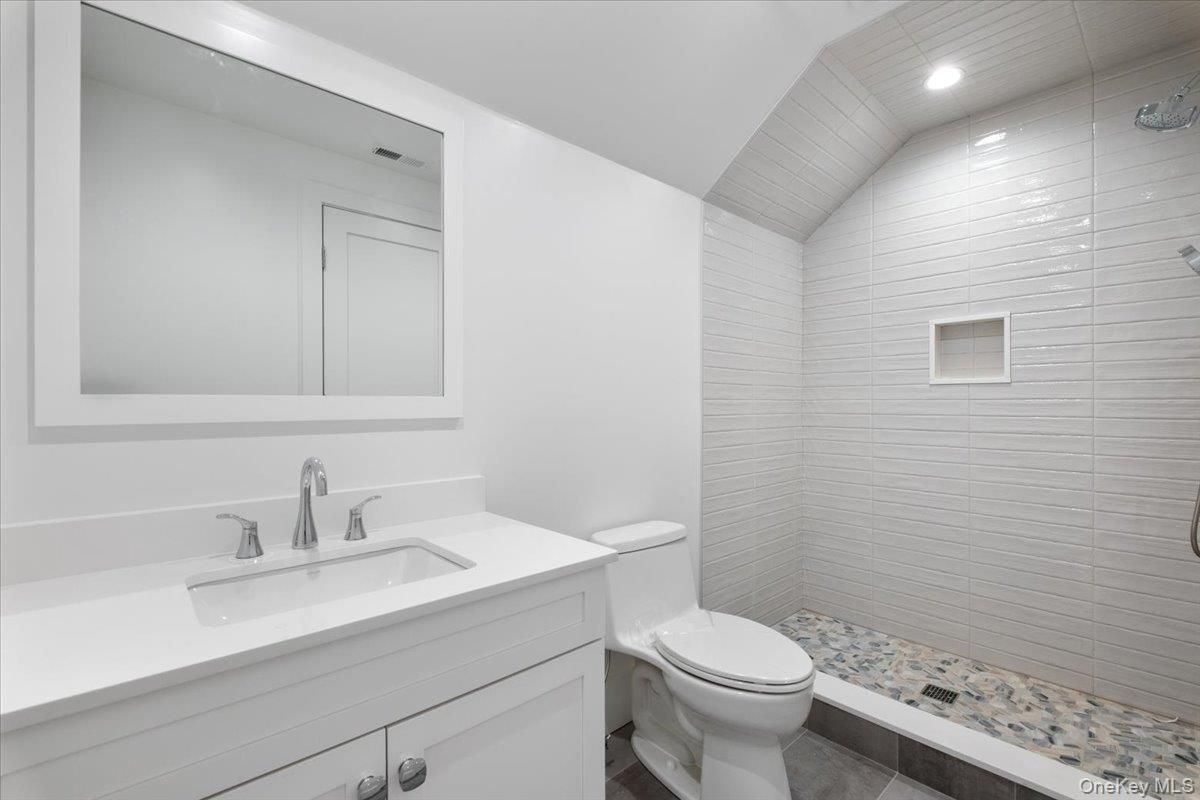 8 Dell Road Scarsdale, NY 10583 - Photo 31 of 41 a bathroom with a sink a toilet and a mirror