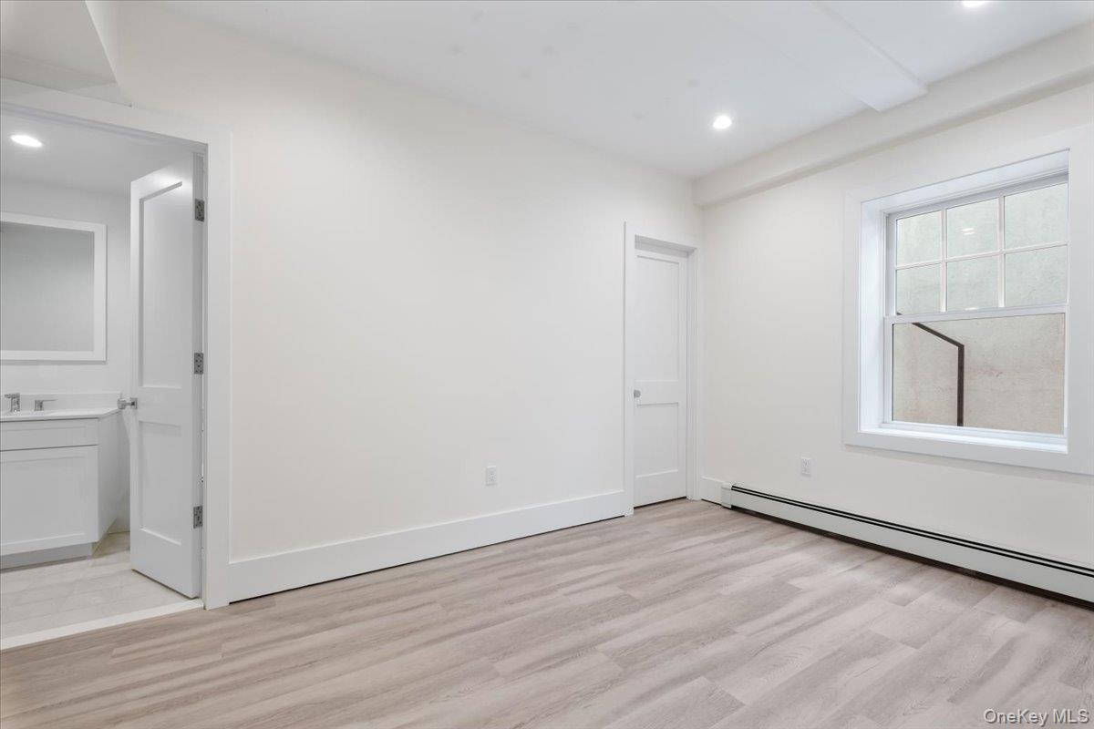 8 Dell Road Scarsdale, NY 10583 - Photo 34 of 41 an empty room with wooden floor and windows