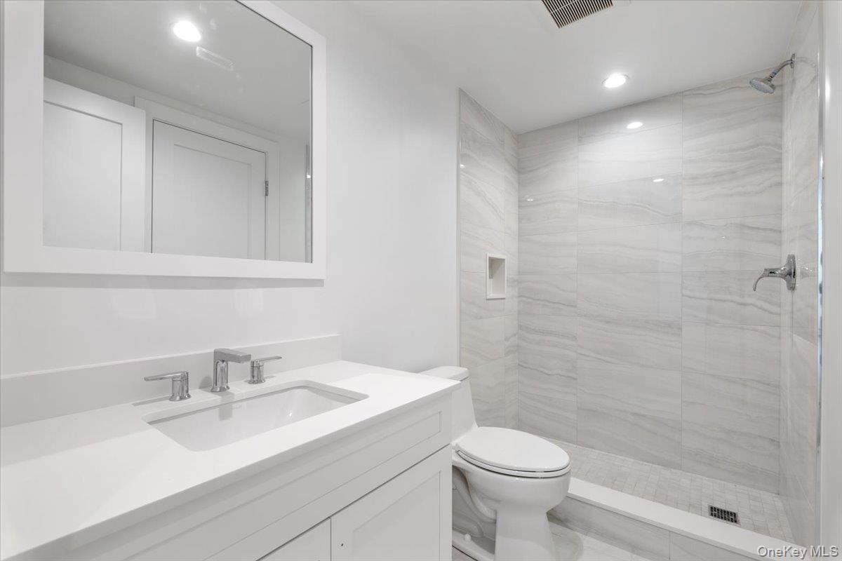 8 Dell Road Scarsdale, NY 10583 - Photo 35 of 41 a bathroom with a sink a toilet and shower