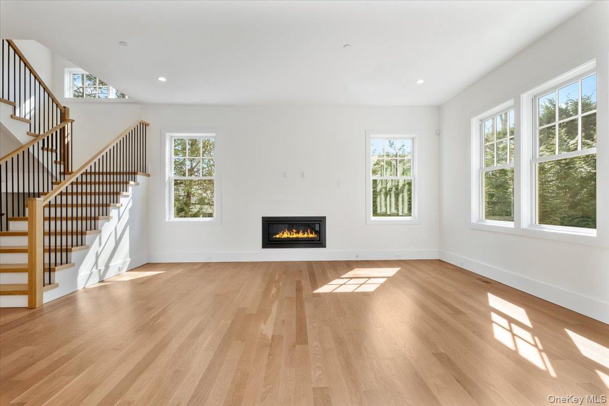8 Dell Road Scarsdale, NY 10583 - Photo 7 of 41 a view of an empty room with wooden floor and a window