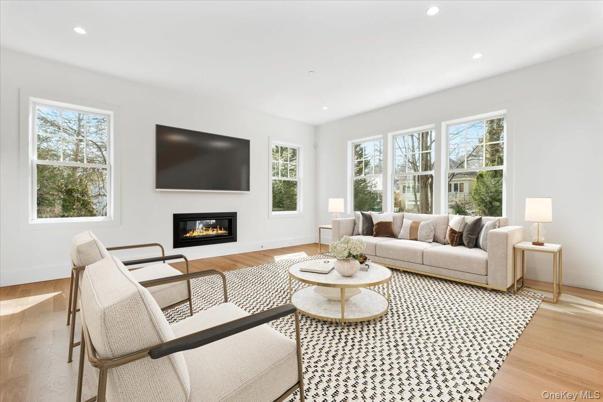 8 Dell Road Scarsdale, NY 10583 - Photo 8 of 41 a living room with furniture a fireplace and a flat screen tv