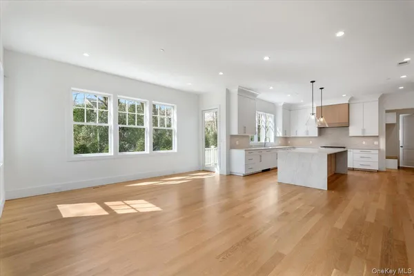 a view of kitchen with wooden floor and windows