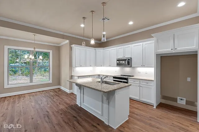 a kitchen with stainless steel appliances granite countertop a stove oven and a refrigerator