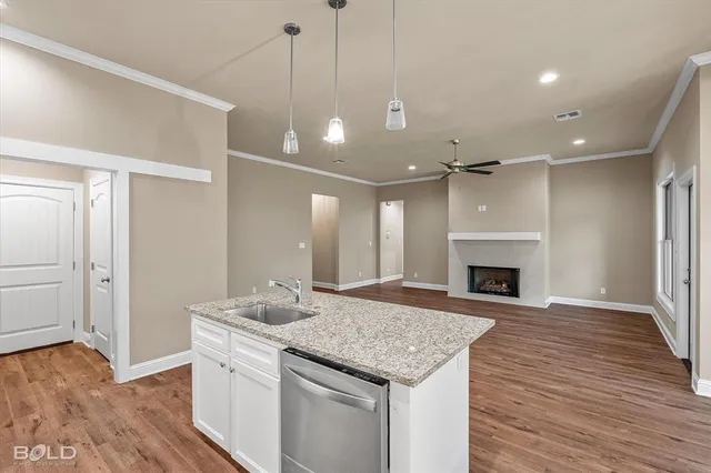 a open kitchen with a sink and a fireplace