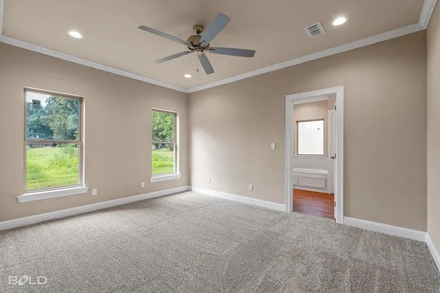 a view of a livingroom with a ceiling fan and window