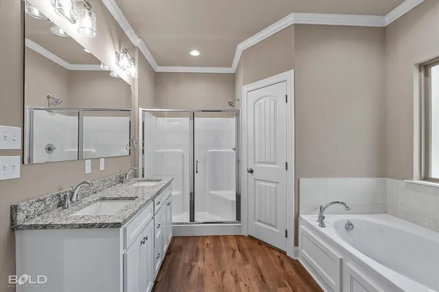 a bathroom with a granite countertop sink mirror bathtub and shower