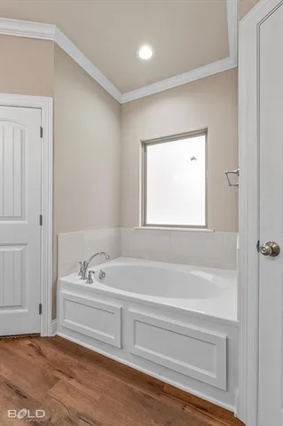 a bathroom with a bathtub and a window