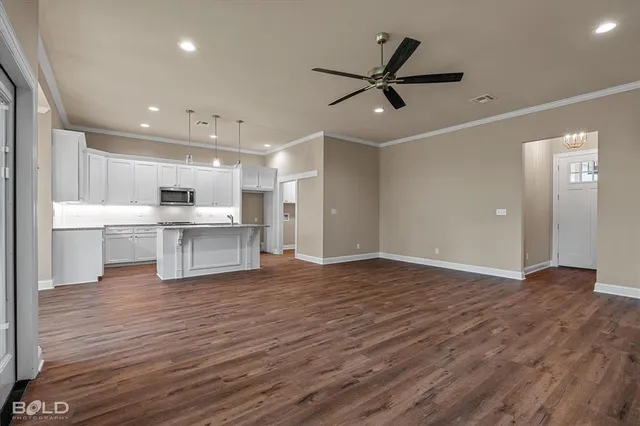 a view of a kitchen with a sink and dishwasher a refrigerator with wooden floor