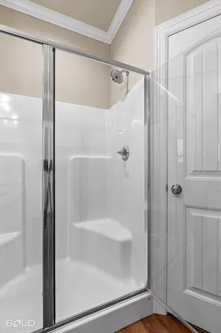 a bathroom with a glass shower door