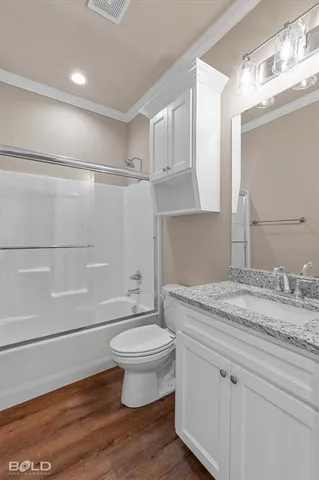 a bathroom with a granite countertop sink toilet and a mirror