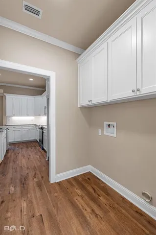 a view of a room with wooden floor and cabinet