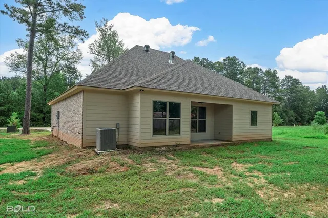 a view of a house with yard and a garden