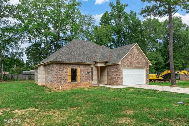 a front view of house with yard and green space