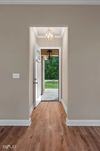a view of a room with wooden floor and small yard