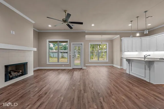 a view of an empty room with a fireplace and a window