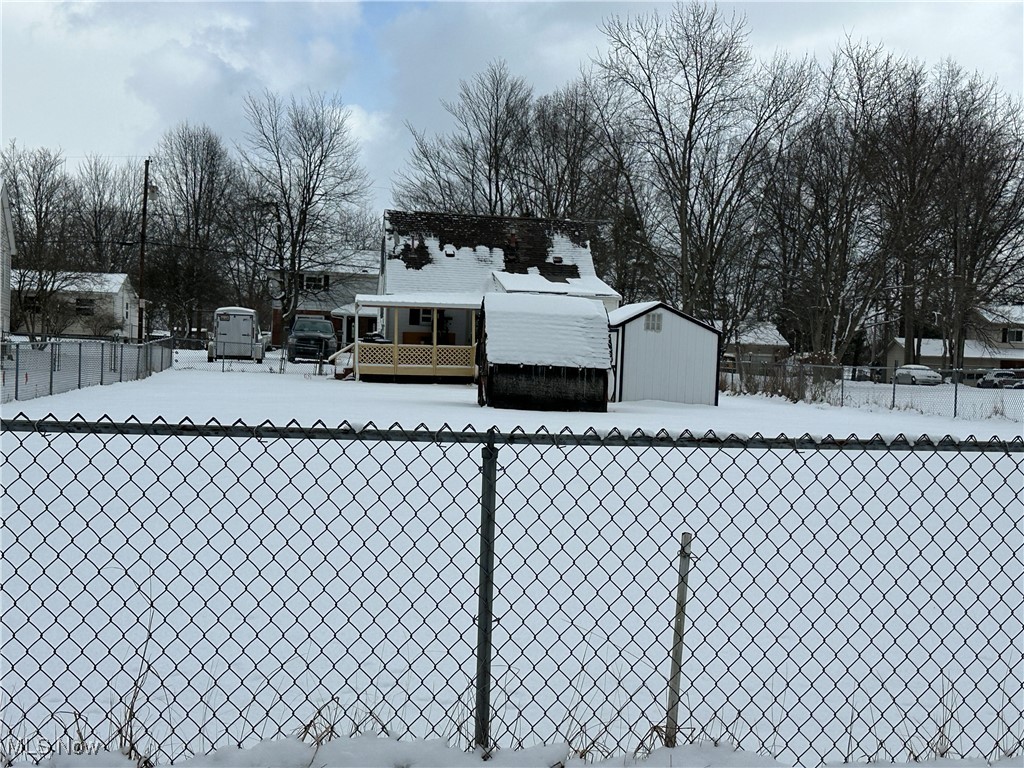 4058 Pardee Road Stow, OH 44224 - Photo 5 of 24 Yard layered in snow with a shed and fence
