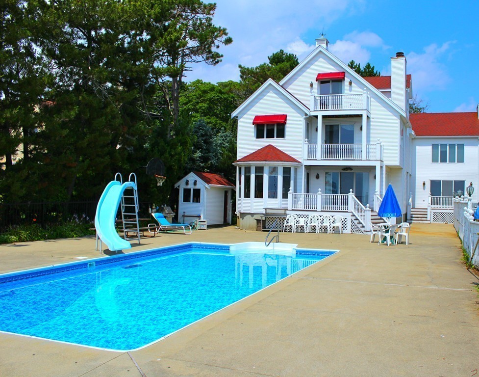 145 Puritan Road Swampscott, MA 01907 - Photo 3 of 19 a view of swimming pool with lounge chair and dinning table under an umbrella
