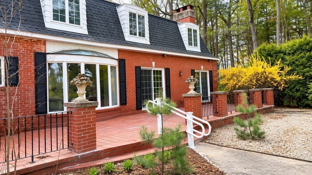 12 Woodland Road Westfield, MA 01085 - Photo 6 of 29 front view of a house with a large window and potted plants